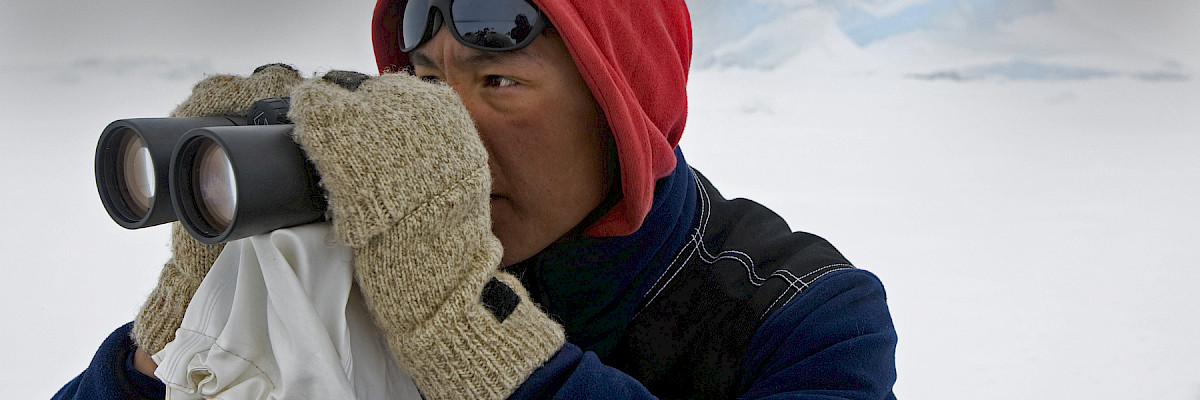 Inuk man with binoculars