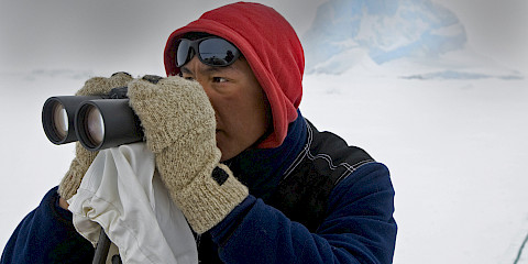 Inuk man with binoculars